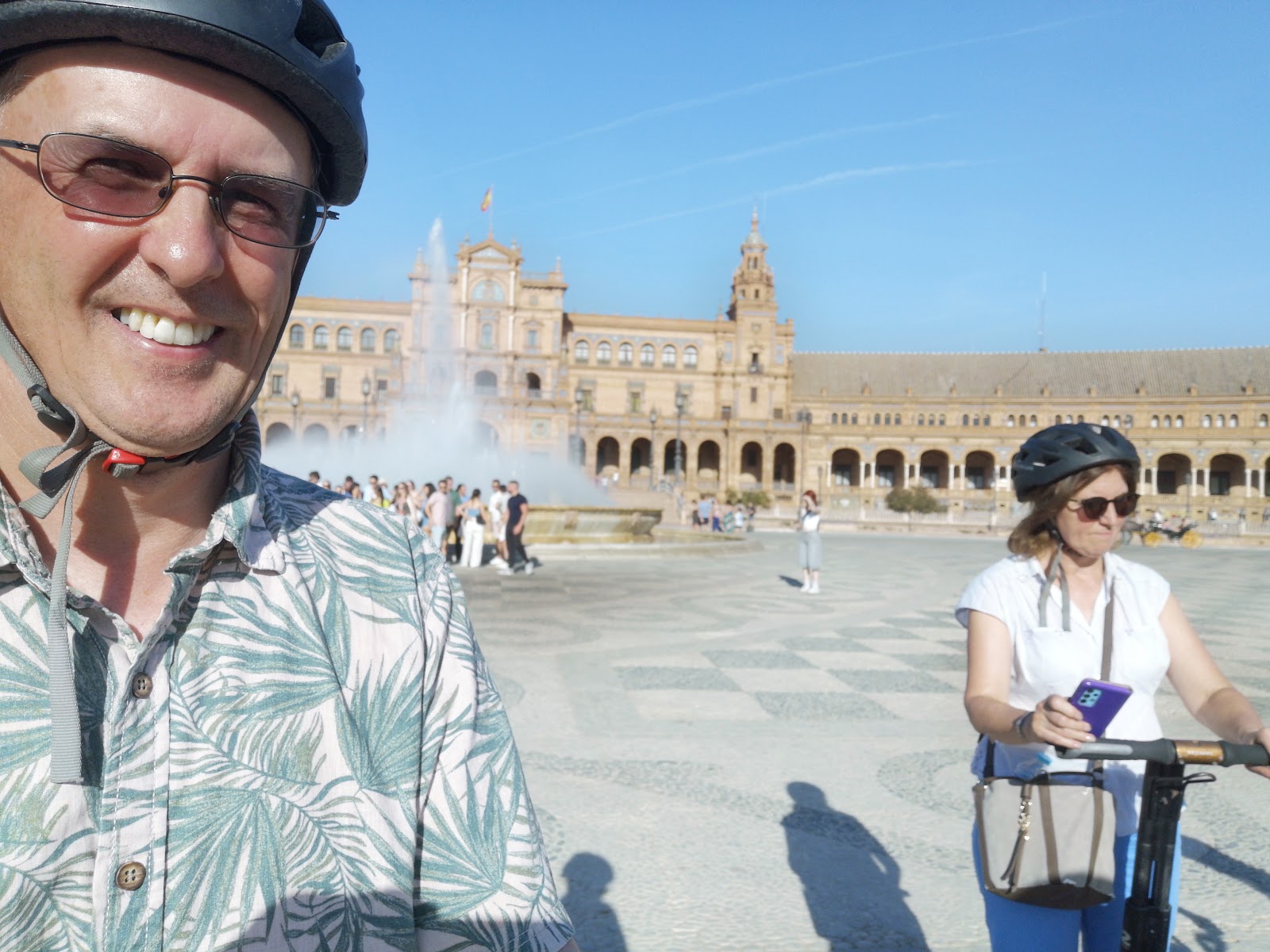 Man on a Segway tour smiling with Plaza de Espana's fountain behind