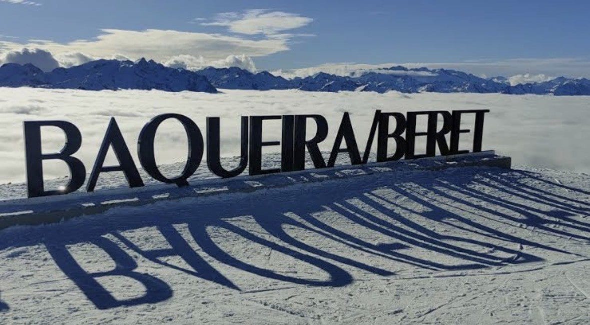 Baqueira/Beret sign above a sea of clouds on the mountain summit