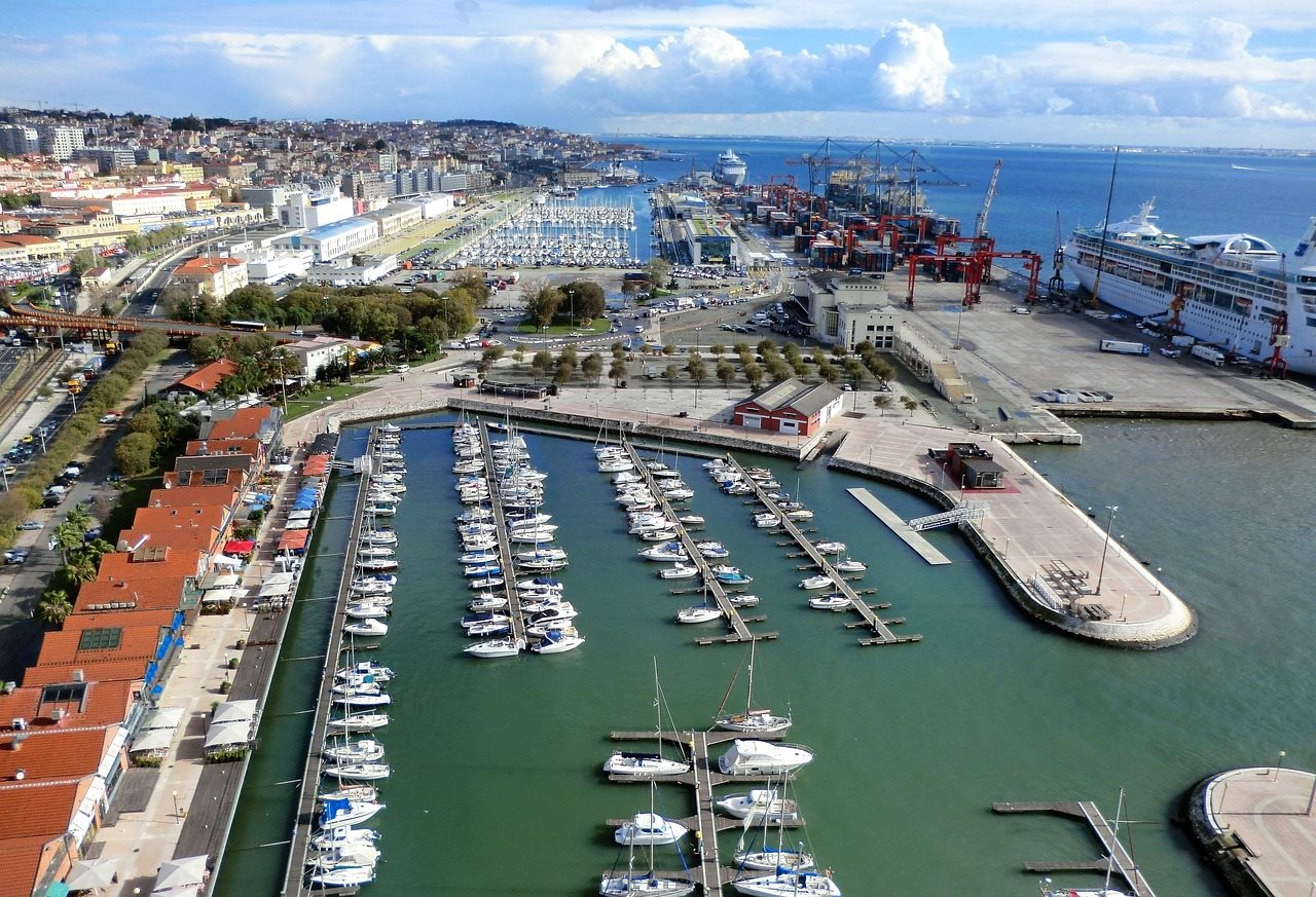 Aerial view of a marina full of moored boats next to the city
