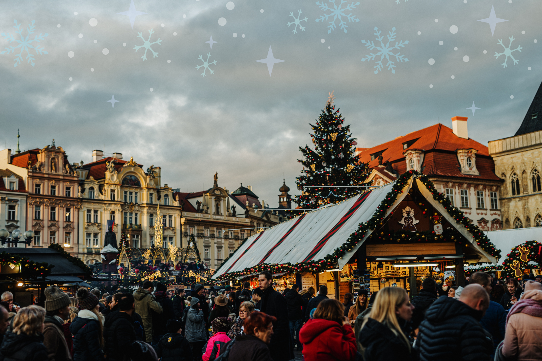 Christmas market stalls and tree in a historic square crowded with visitors