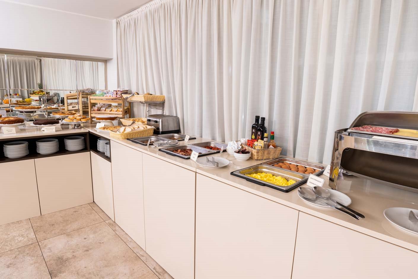 Hotel breakfast buffet with pastries, cold cuts and fruit