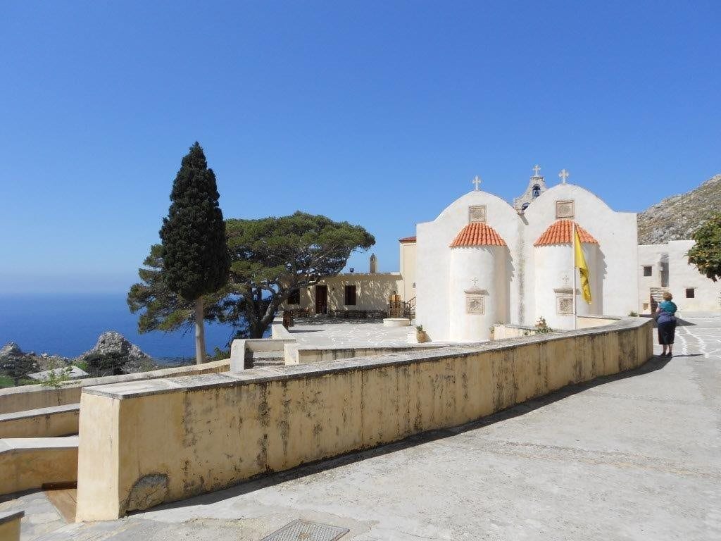 Twin-domed whitewashed chapel on a clifftop overlooking the sea