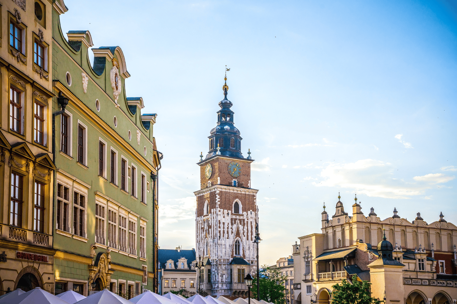 Gothic town hall tower and historic buildings in a European town square