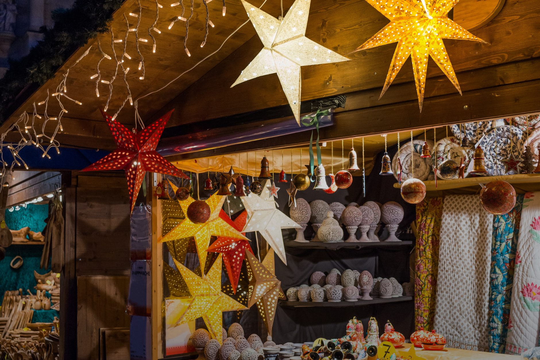 Market stall hung with star-shaped lanterns and ceramic ornaments