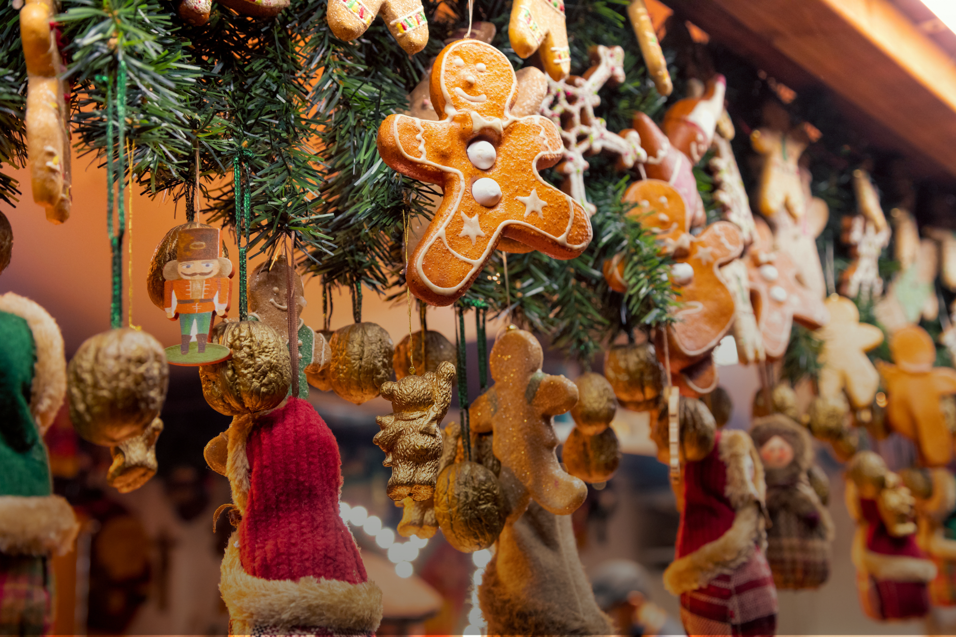 Gingerbread-shaped ornaments hanging at a Christmas market stall